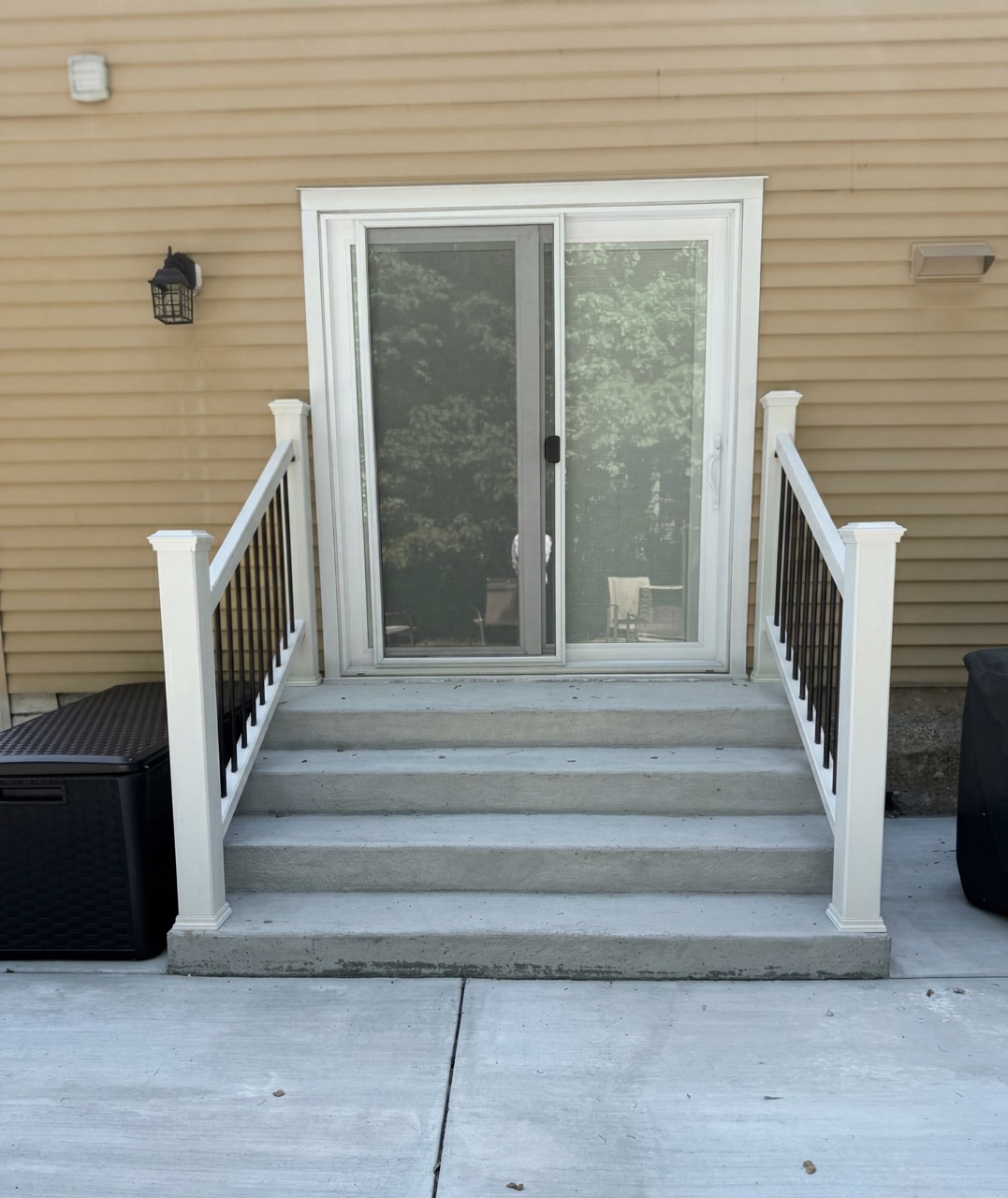 Concrete patio and steps with railings by Green Life Landscaping